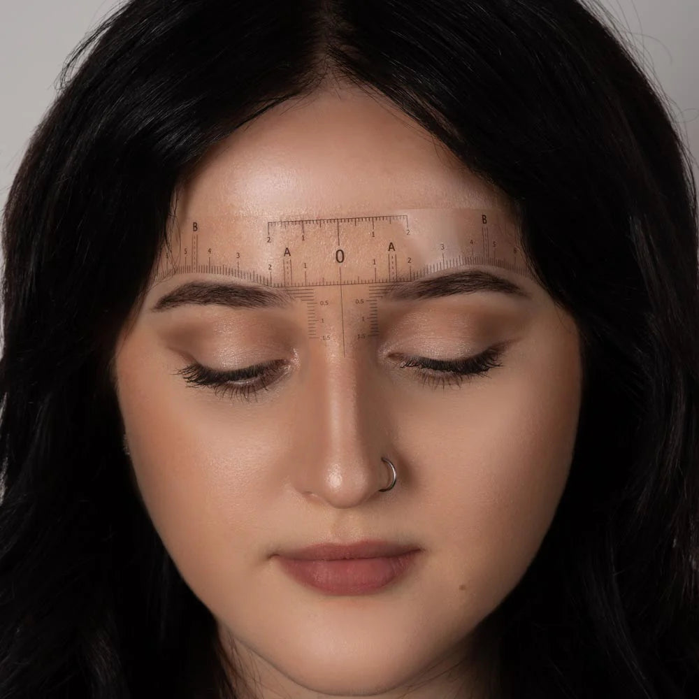 Saferly disposable eyebrow ruler stickers roll with 50 clear adhesive strips for precise eyebrow shaping and measurement.